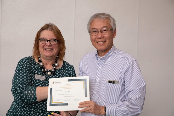 Two people holding a certificate